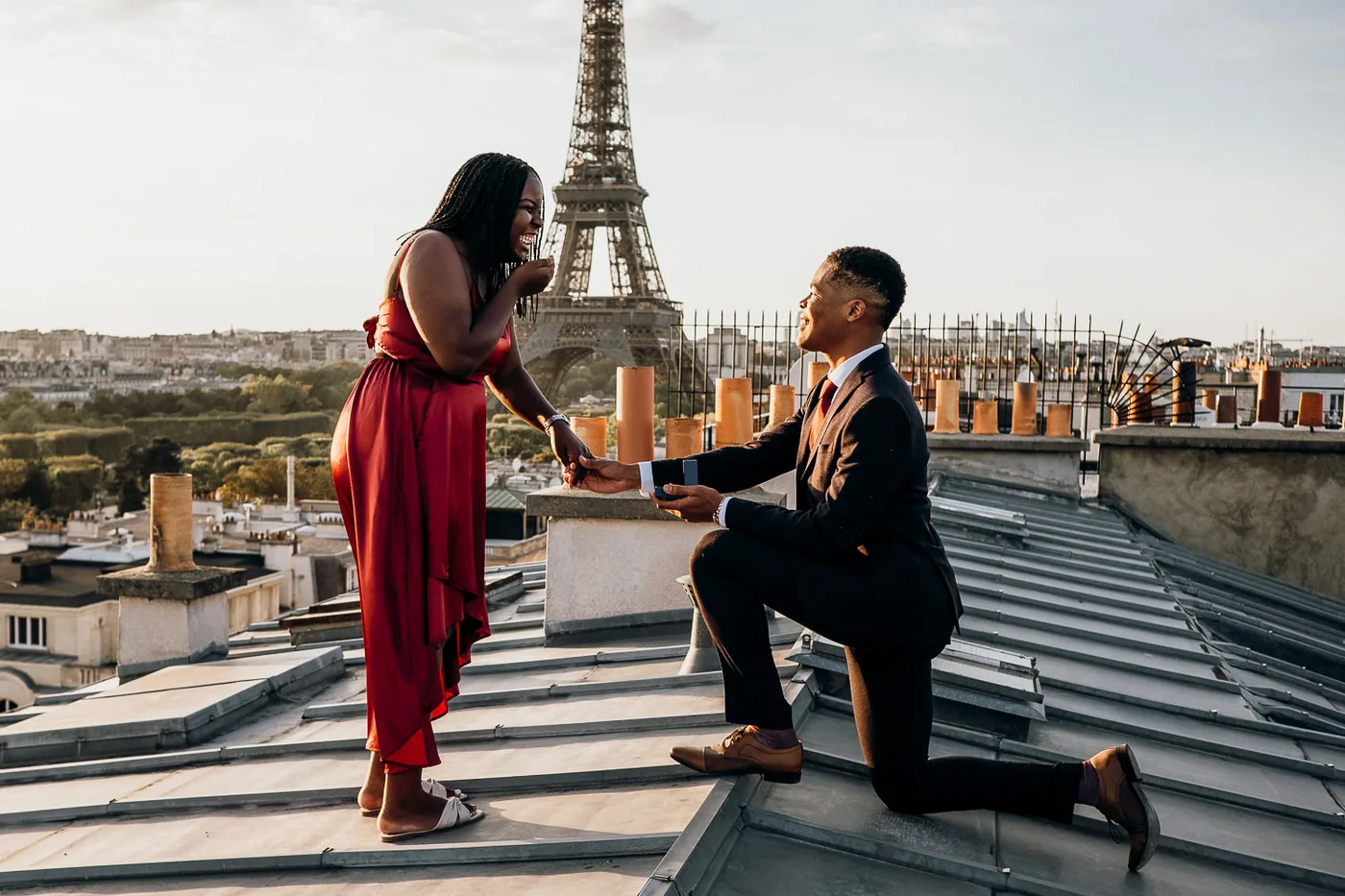 Rooftop Romance: Proposal in Paris with a Parisian Skyline.
