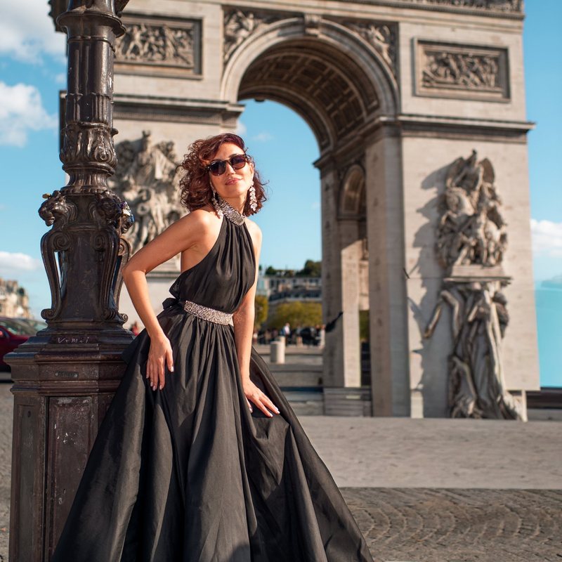 Woman in a black halter gown at the Arc de Triomphe, Place Charles de Gaulle